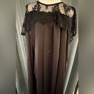 The Paragon black lace dress size shows 0/S I think it is more like a 1X